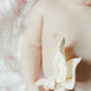 baby holding bunny teethers