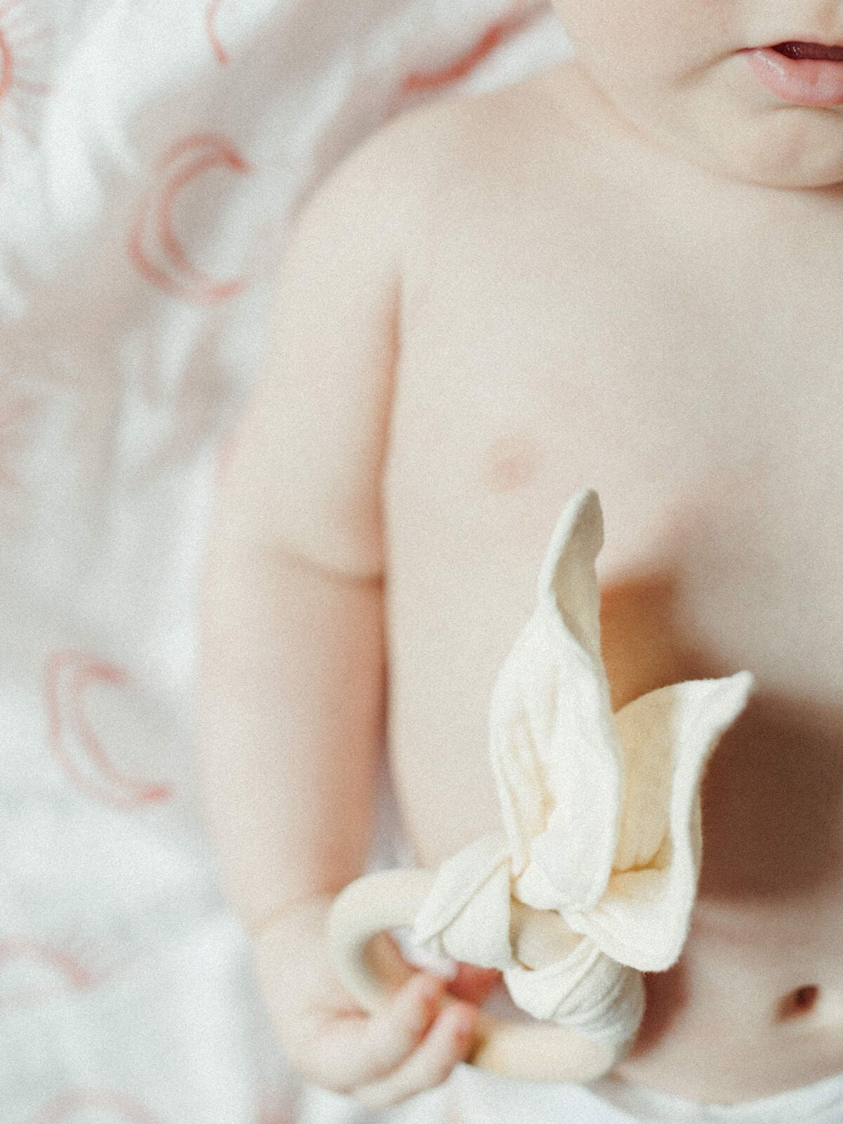 baby holding bunny teethers